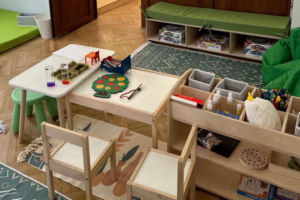 Bright Montessori play room with natural wood furniture