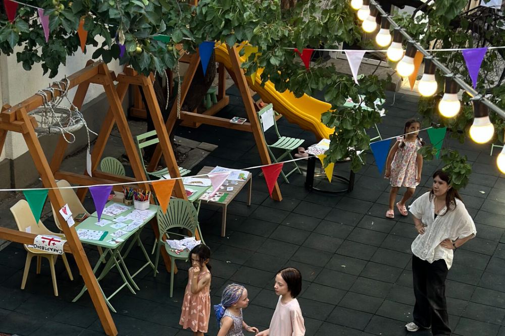 Children playing outdoors under bunting